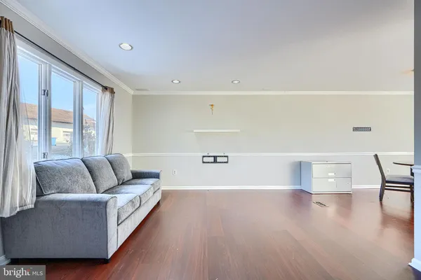 a living room with furniture and a hard wood floor