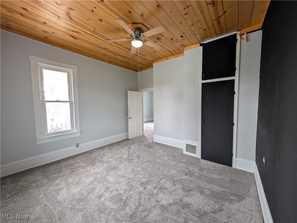 10143 Pleasant Road Pleasant City, OH 43772 - Photo 15 of 32 Unfurnished bedroom with carpet flooring, wood ceiling, and a ceiling fan