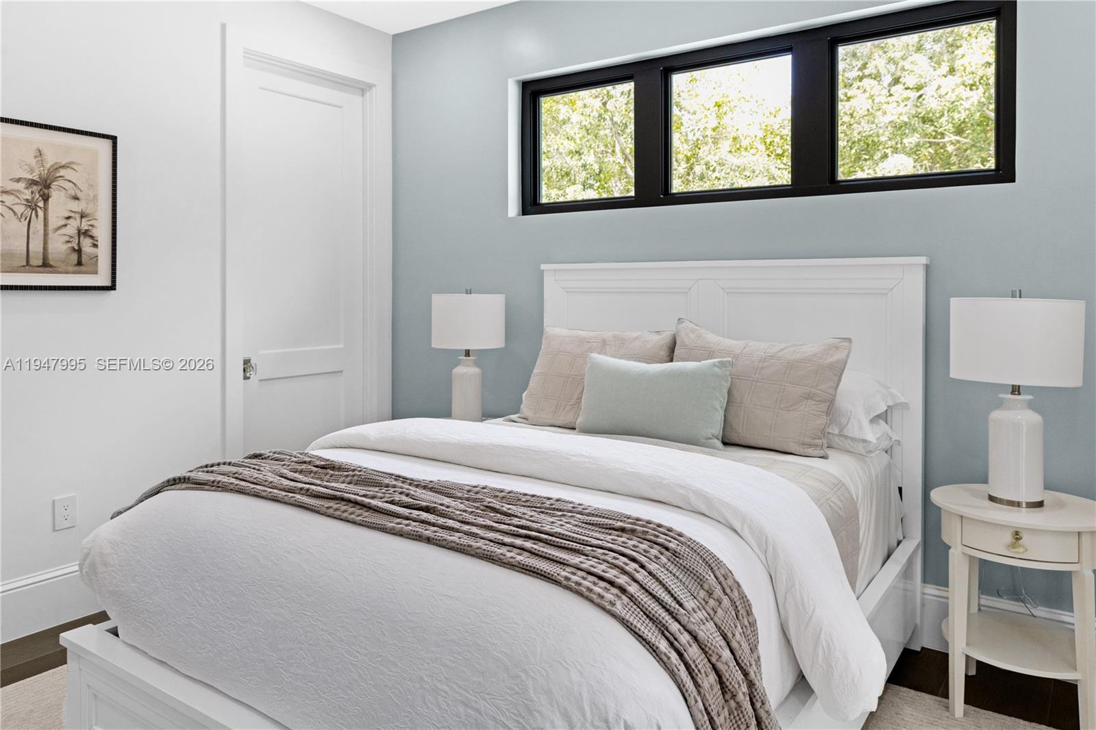 44 Card Sound Road Key Largo, FL 33037 - Photo 16 of 18 a bedroom with a bed and a lamp on dresser