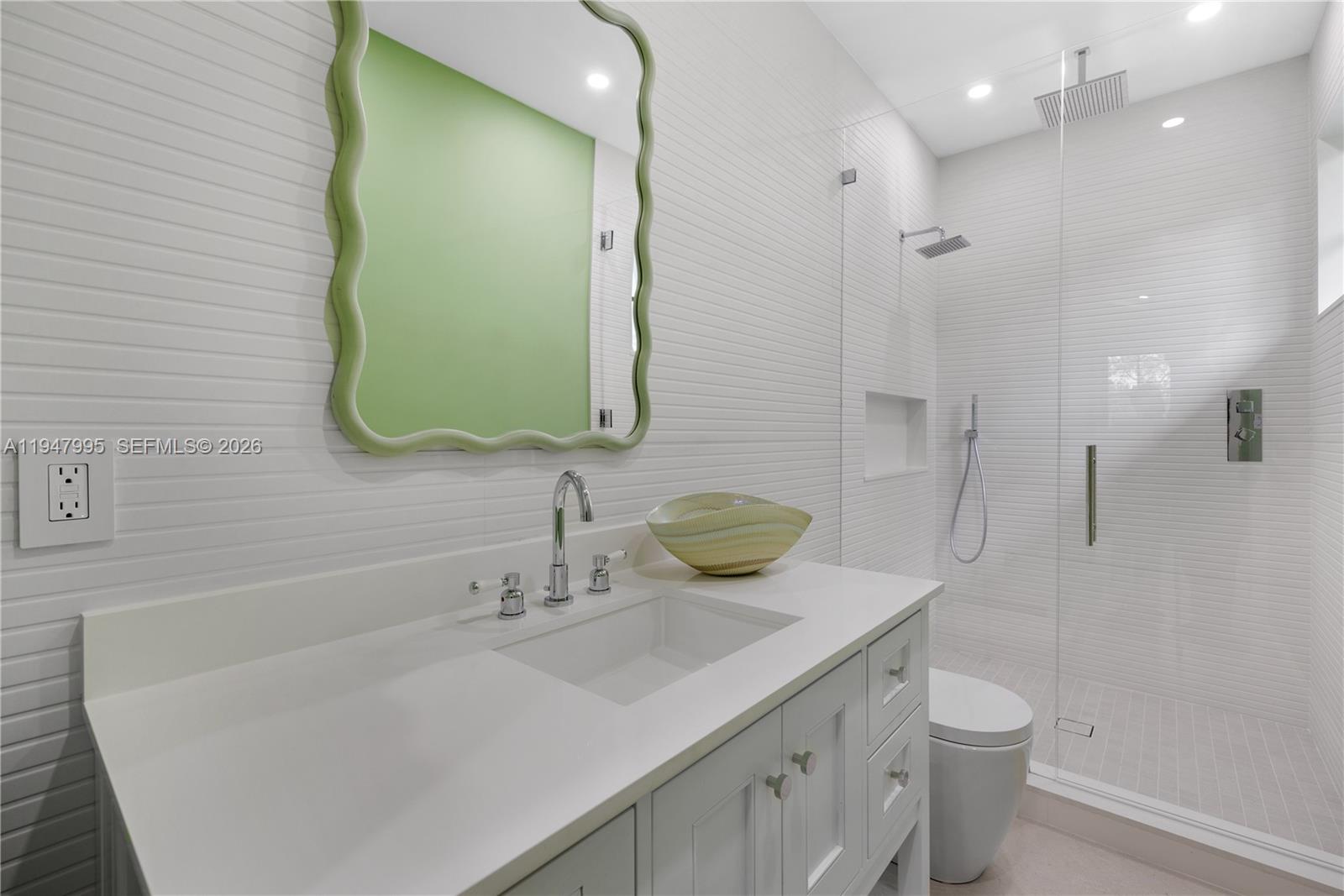 44 Card Sound Road Key Largo, FL 33037 - Photo 4 of 18 a bathroom with a sink a toilet and a mirror