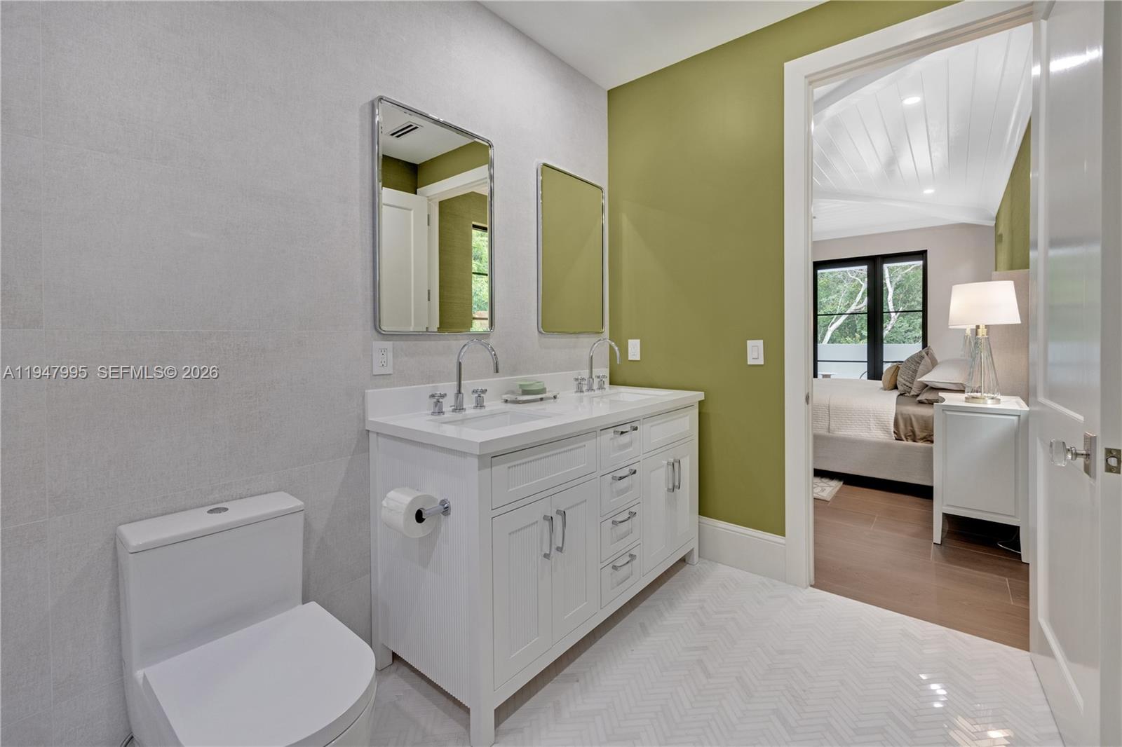 44 Card Sound Road Key Largo, FL 33037 - Photo 9 of 18 a spacious bathroom with a double vanity sink toilet and a mirror