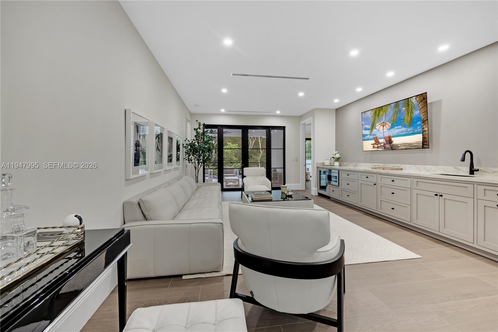 44 Card Sound Road Key Largo, FL 33037 - Photo 10 of 18 a living room with furniture and a large window