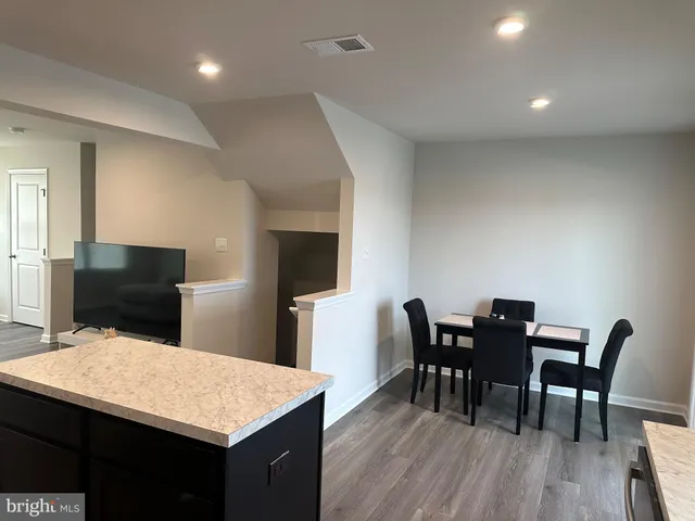 a kitchen with a table and chairs in it
