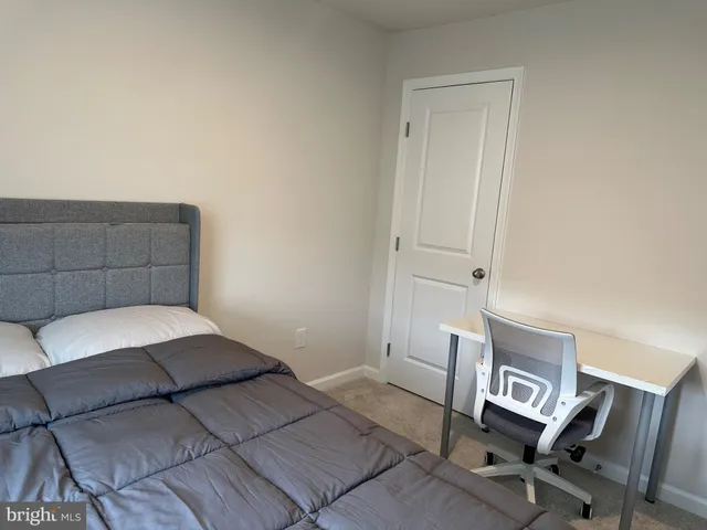 a bedroom with a bed and a chair