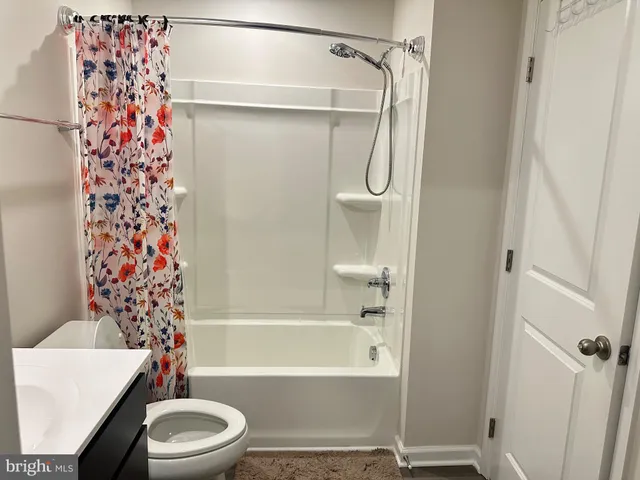 a bathroom with a toilet and shower