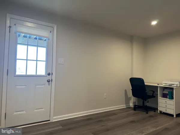 a view of workspace room with wooden floor and windows