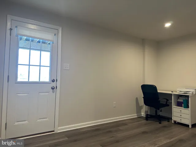 a view of workspace room with wooden floor and windows