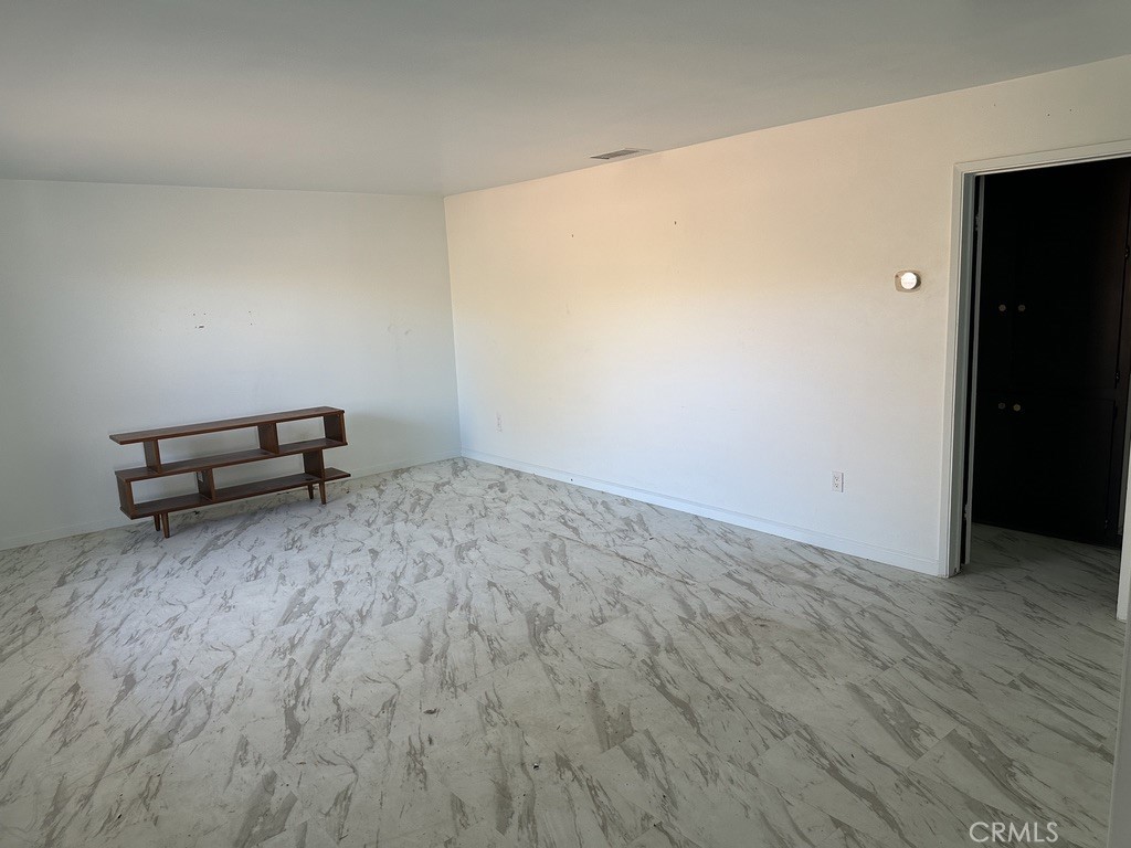 7428 Acoma Trail, Unit 2 Yucca Valley, CA 92284 - Photo 3 of 15 a view of a room with wooden floor and bench