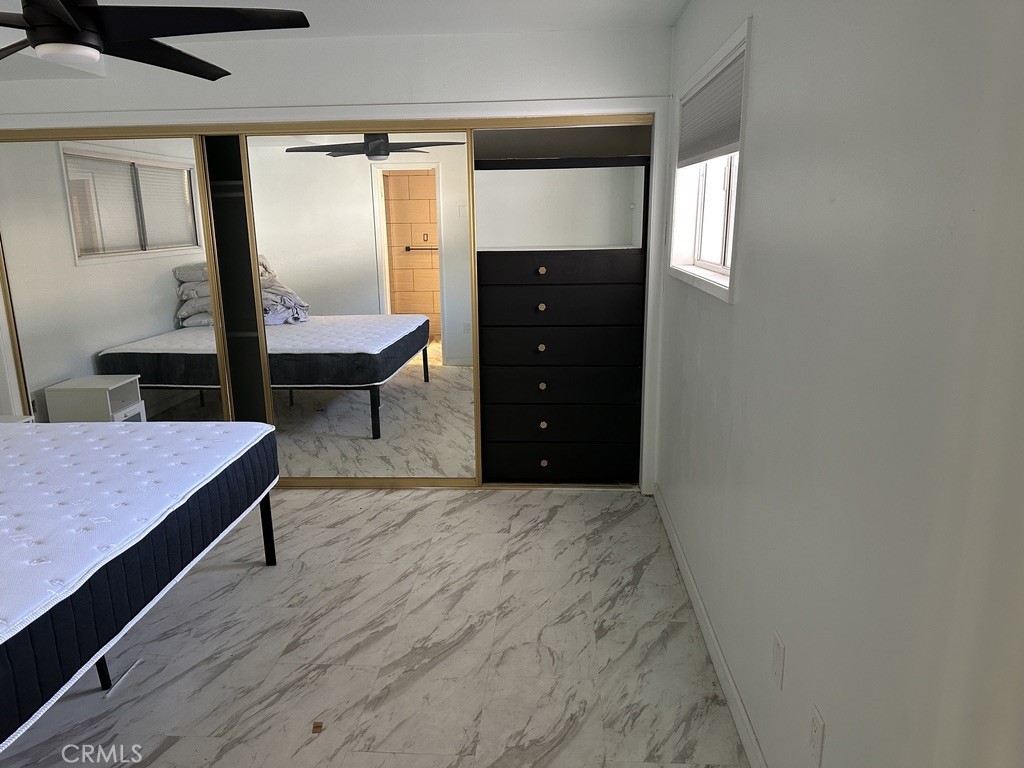 7428 Acoma Trail, Unit 2 Yucca Valley, CA 92284 - Photo 6 of 15 a living room with furniture and wooden floor