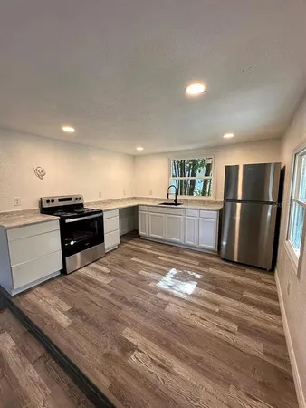 a view of kitchen and empty room