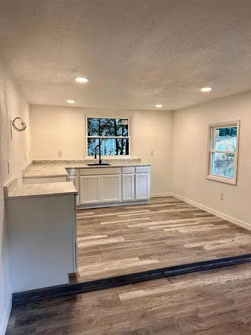 a view of a room with wooden floor and staircase