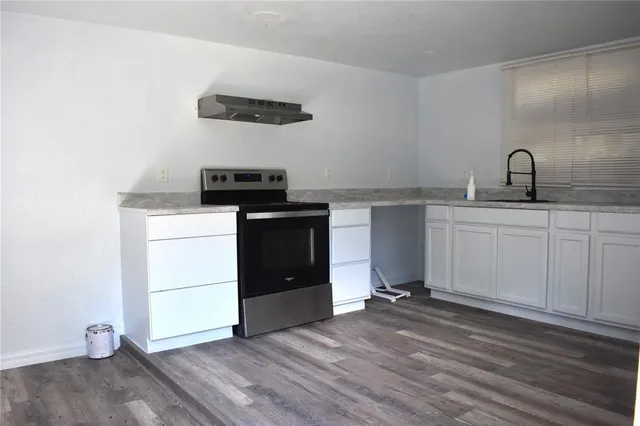 a kitchen with a sink a stove and refrigerator