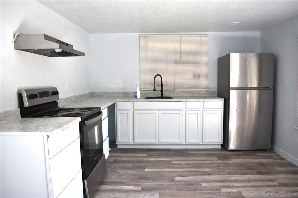 1954 Boat Club Road Oviedo, FL 32765 - Photo 9 of 20 a kitchen with a sink a stove and refrigerator