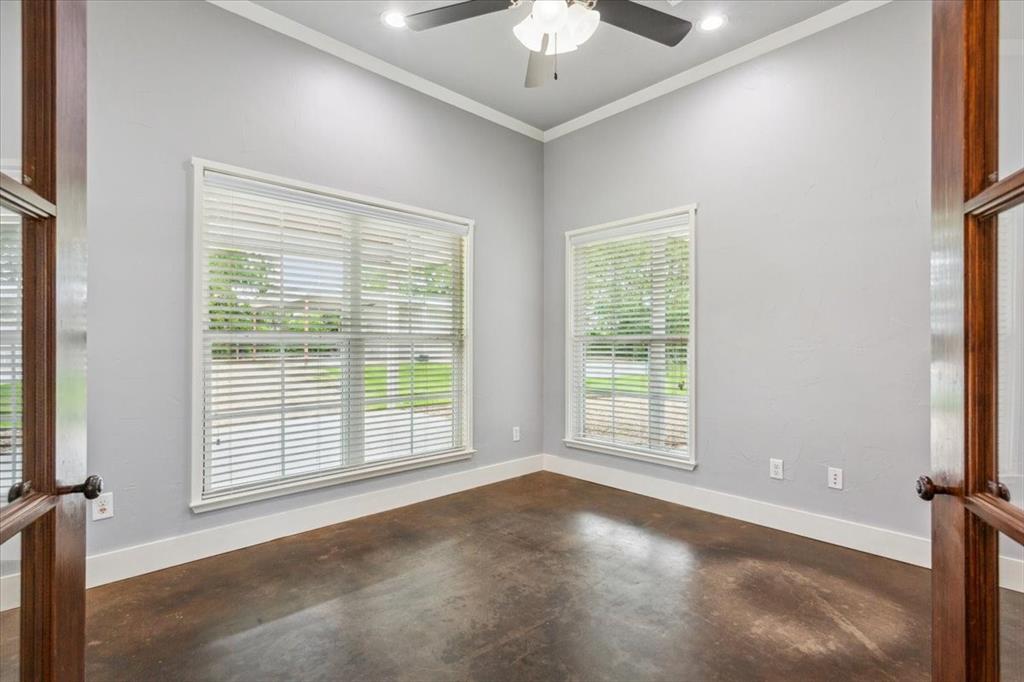 259 County Road 149 Riesel, TX 76682 - Photo 13 of 40 Unfurnished room with finished concrete floors, ceiling fan, ornamental molding, baseboards, and recessed lighting