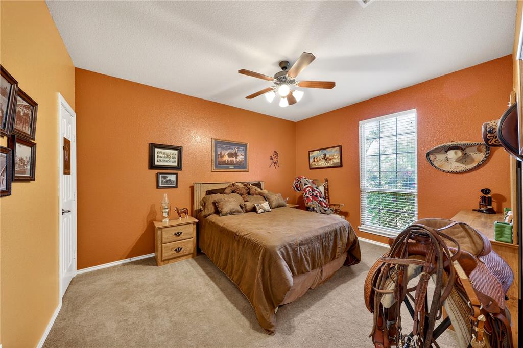 1035 Highland Road Cleburne, TX 76033 - Photo 23 of 36 a bedroom with a bed chandelier and a window