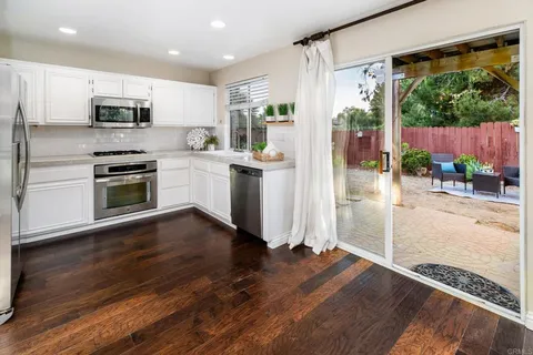 a kitchen with a refrigerator and a stove