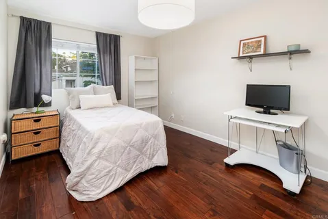 a bedroom with a bed and a tv on table
