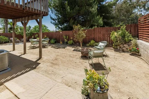 a view of a backyard with sitting area