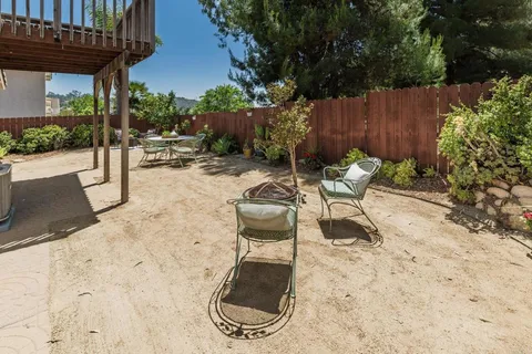 a view of a backyard with sitting area