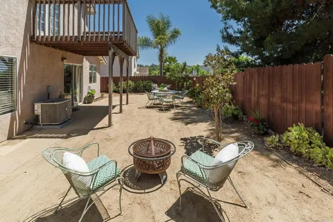 a view of a patio with couches chairs and a potted plant