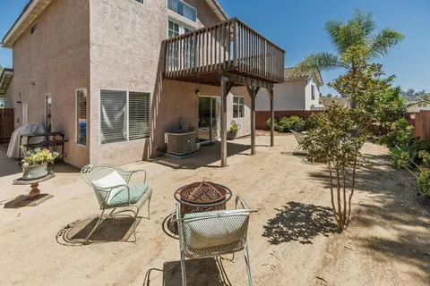 a view of a patio with table and chairs and potted plants