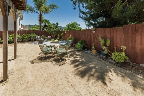 a view of a backyard with sitting area