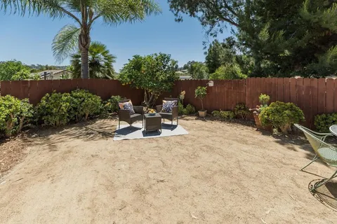 a backyard of a house with yard and outdoor seating