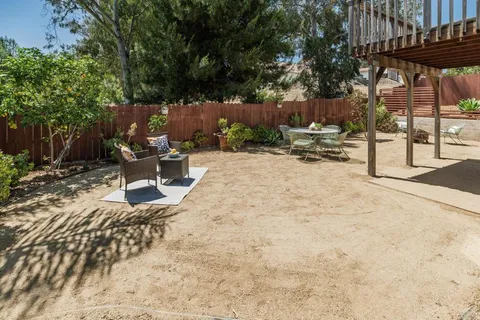 a view of a backyard with sitting area