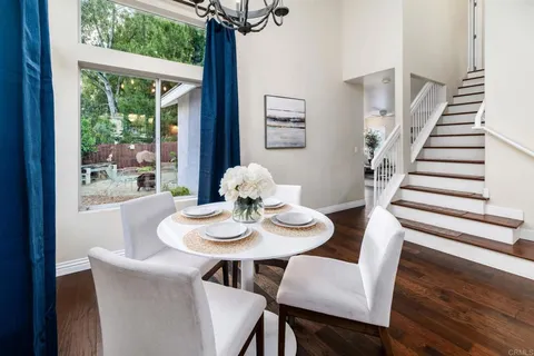 a view of a dining room with furniture wooden floor and chandelier