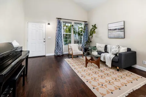 a living room with furniture windows and a wooden floor