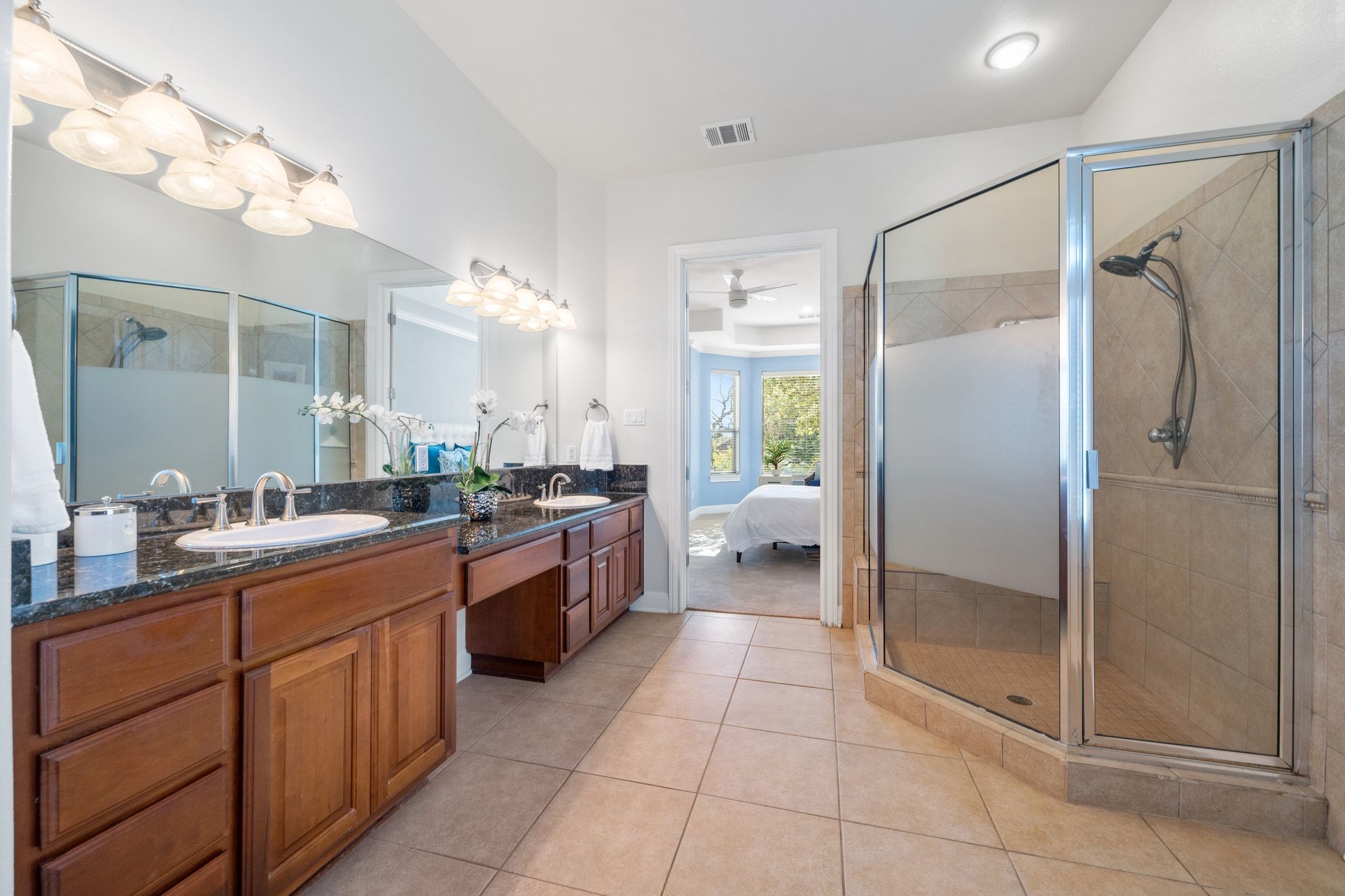 15201 Bat Hawk Circle Austin, TX 78738 - Photo 16 of 33 a large bathroom with a glass door shower a sink and a mirror