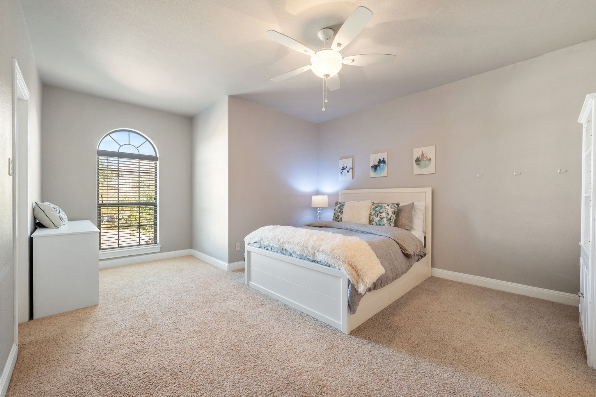 15201 Bat Hawk Circle Austin, TX 78738 - Photo 23 of 33 a spacious bedroom with a bed chandelier and a window