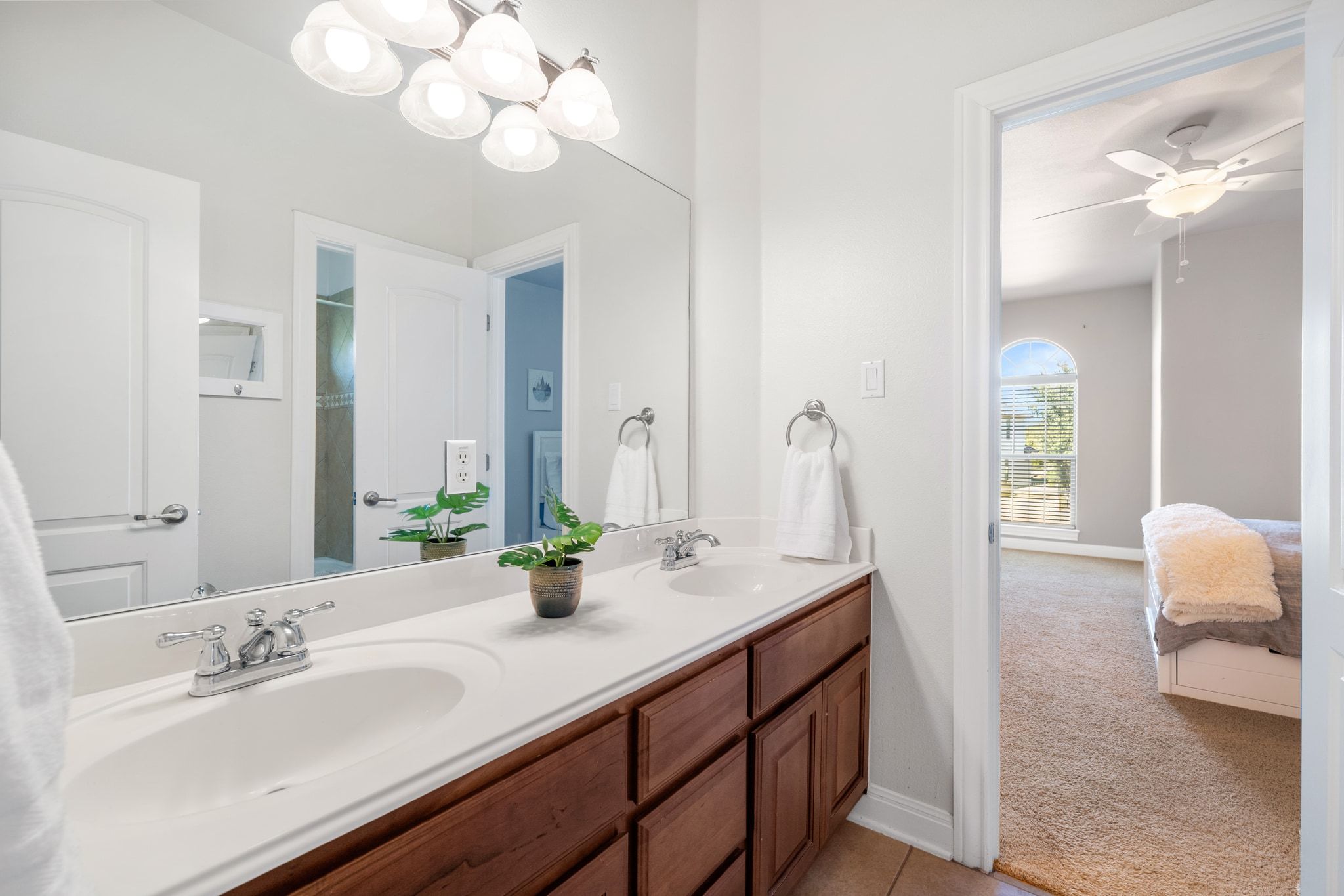 15201 Bat Hawk Circle Austin, TX 78738 - Photo 25 of 33 a bathroom with a double vanity sink and a mirror