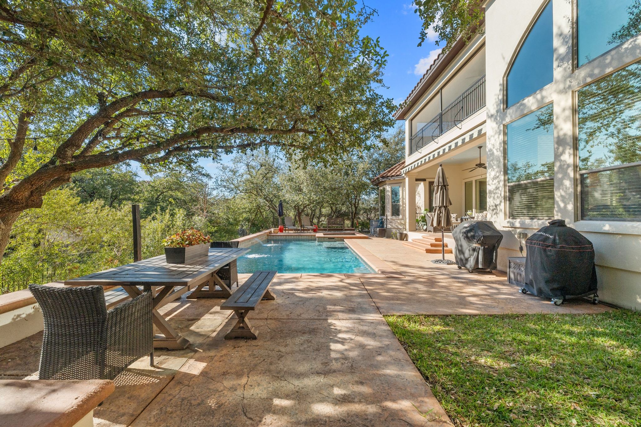 15201 Bat Hawk Circle Austin, TX 78738 - Photo 30 of 33 a view of a patio with table and chairs with wooden fence and plants
