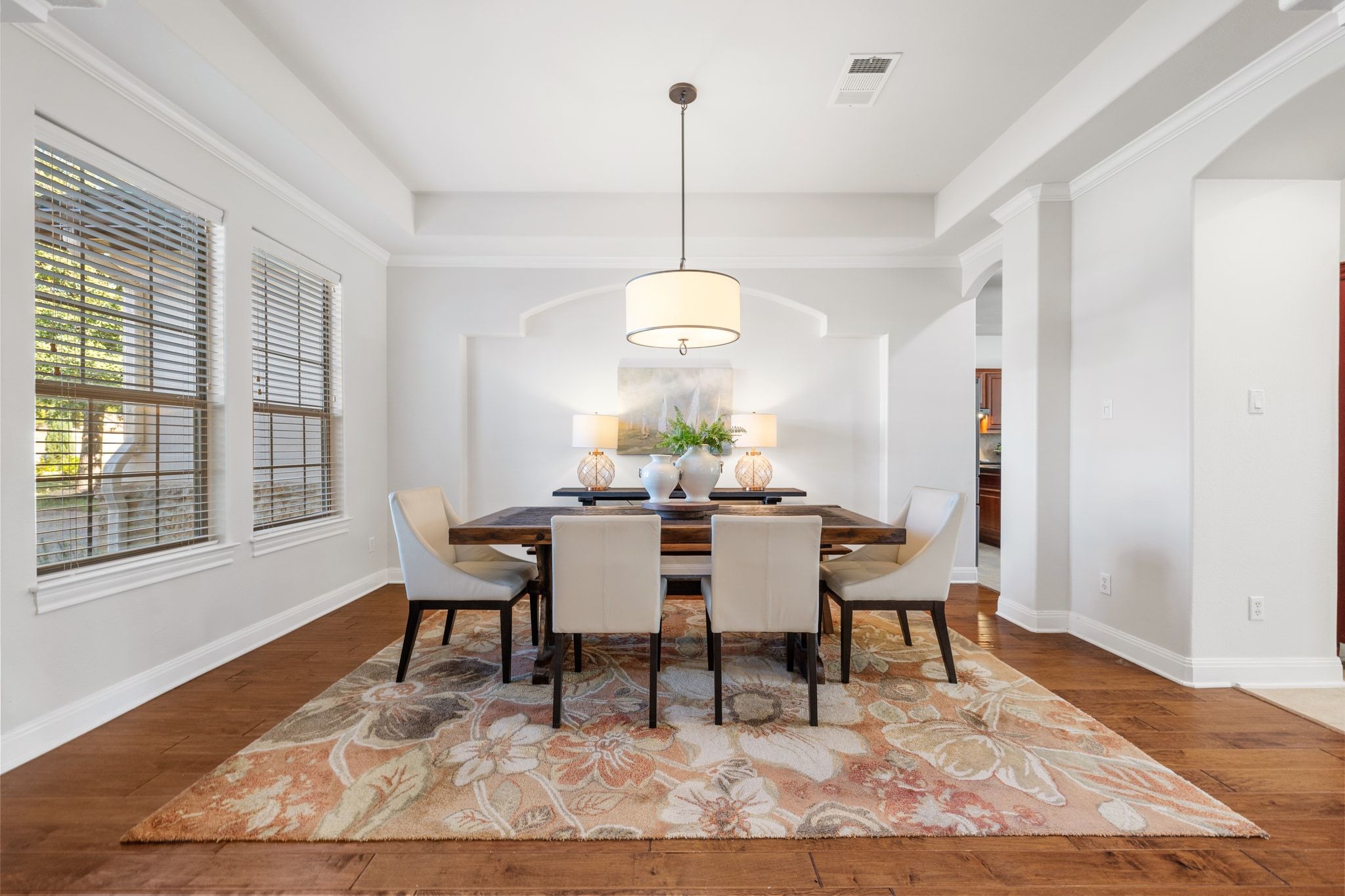 15201 Bat Hawk Circle Austin, TX 78738 - Photo 3 of 33 a dining room with furniture a rug and wooden floor