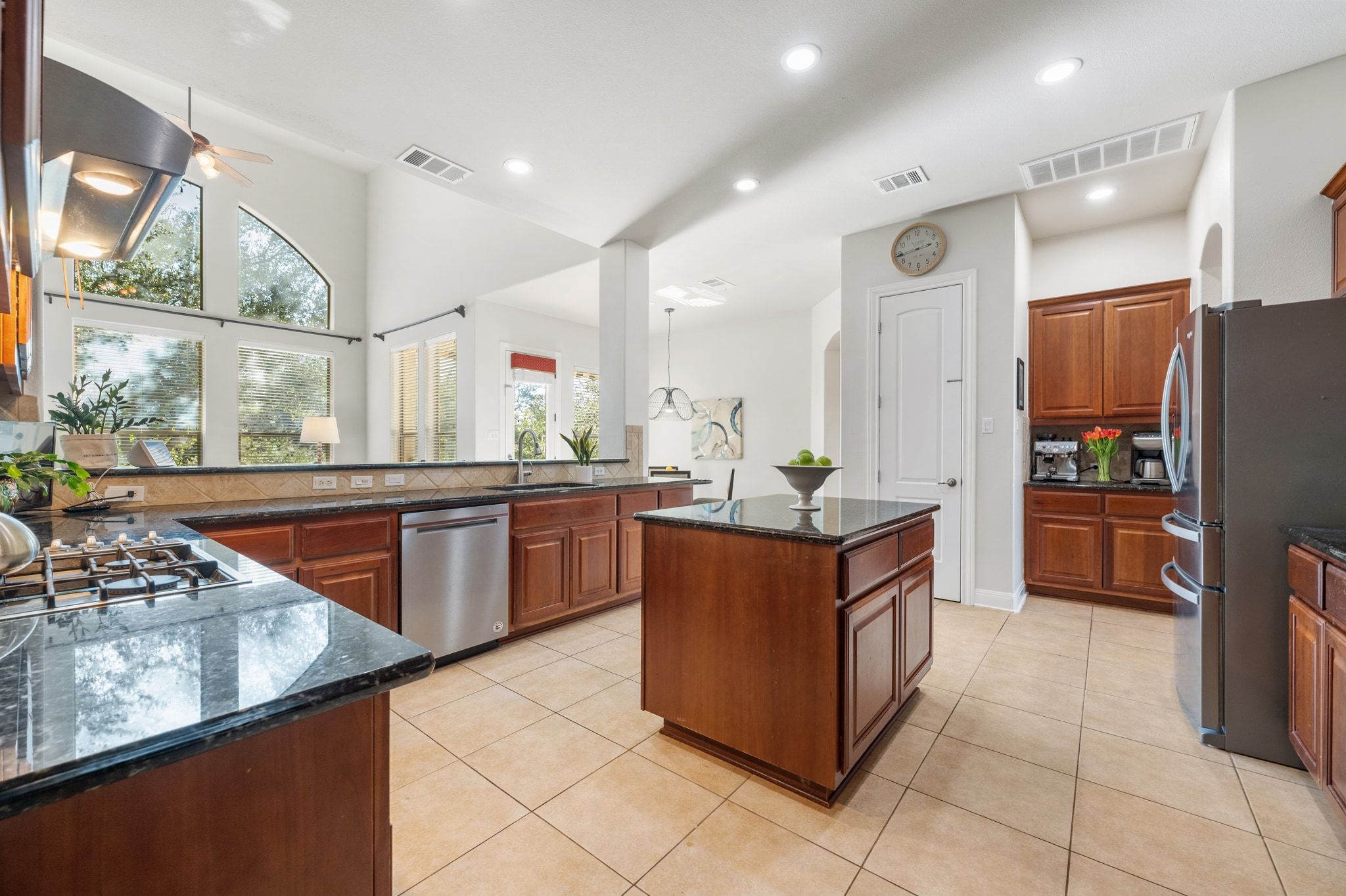 15201 Bat Hawk Circle Austin, TX 78738 - Photo 9 of 33 a kitchen with stainless steel appliances granite countertop a stove a sink and a refrigerator