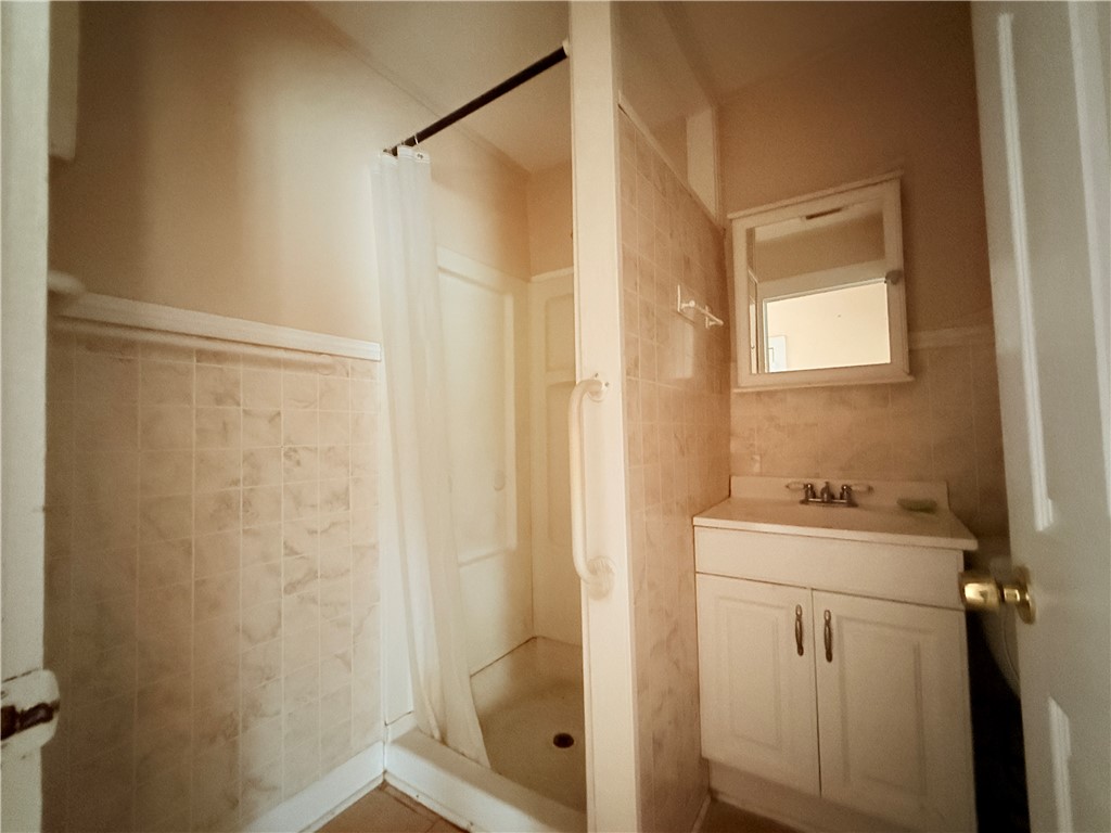 809 Cook, Unit A&B Odem, TX 78370 - Photo 11 of 12 a bathroom with a sink a toilet and shower