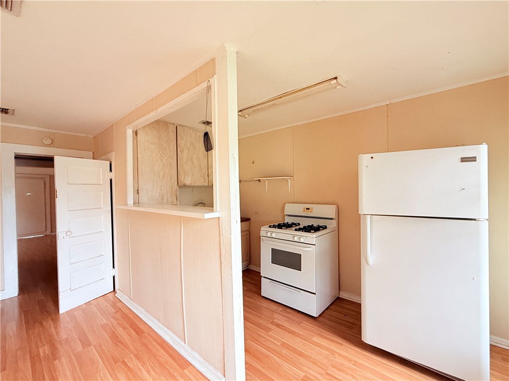 809 Cook, Unit A&B Odem, TX 78370 - Photo 4 of 12 a white refrigerator freezer and a stove sitting inside of a kitchen