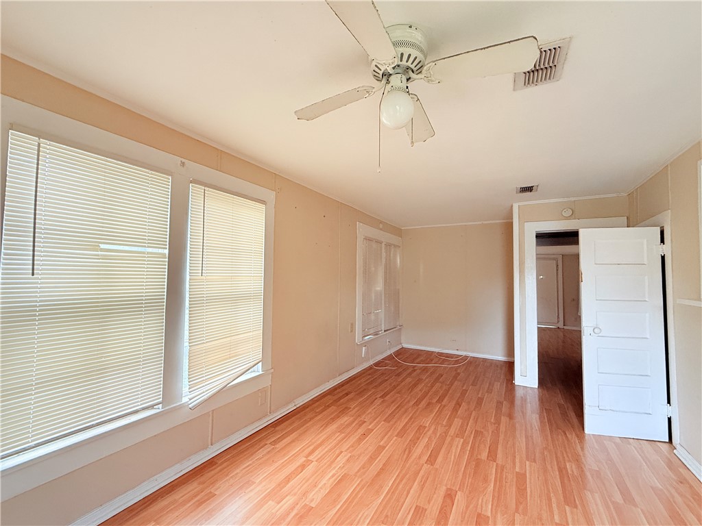 809 Cook, Unit A&B Odem, TX 78370 - Photo 5 of 12 a view of empty room with wooden floor and fan