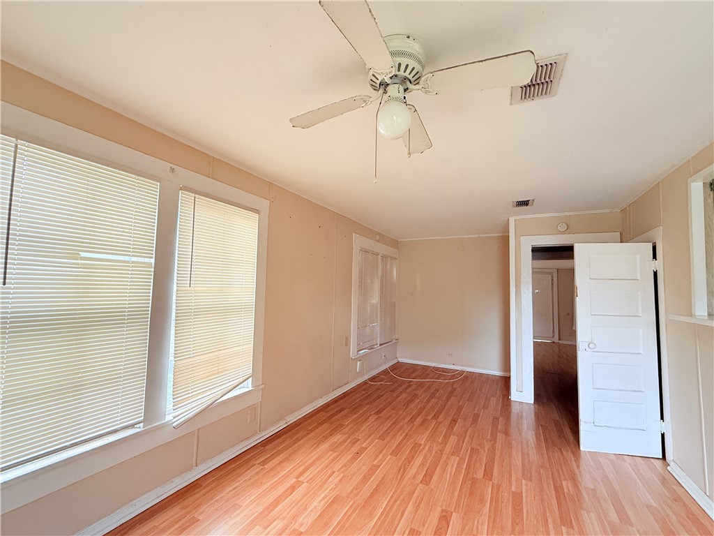 809 Cook, Unit A&B Odem, TX 78370 - Photo 6 of 12 a view of empty room with wooden floor and ceiling fan