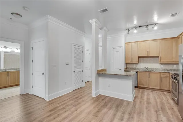 a view of kitchen with granite countertop cabinets and sink