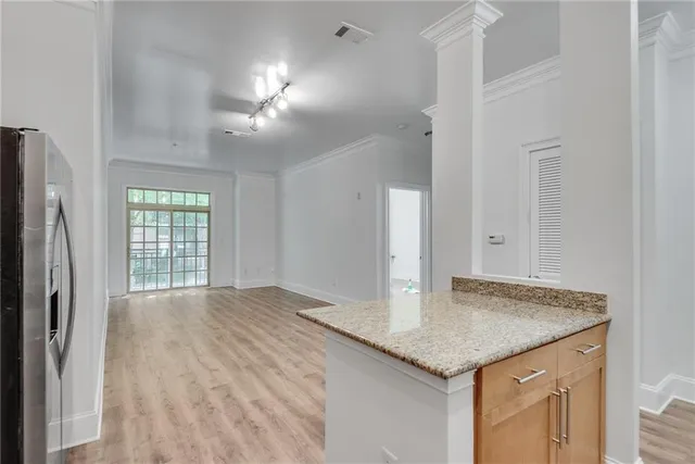 a kitchen with granite countertop kitchen island a sink appliances and a counter space