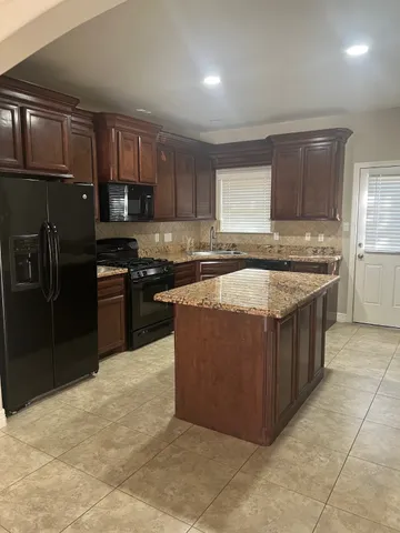 a kitchen with a stove a sink and a refrigerator