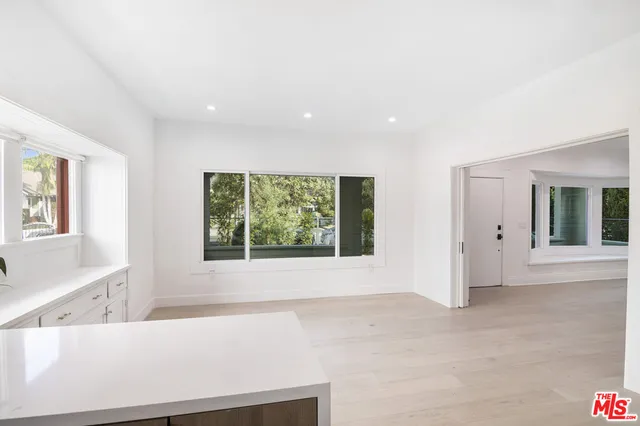 a view of kitchen with sink and refrigerator