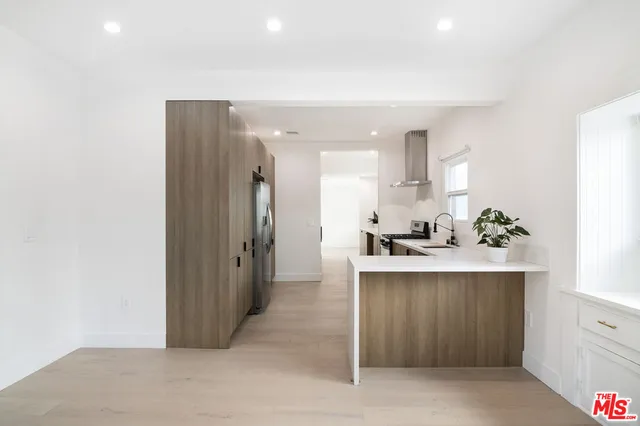 a kitchen with stainless steel appliances a sink stove and refrigerator