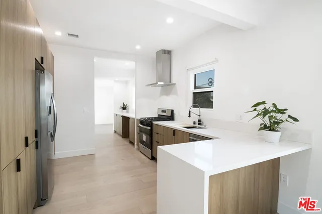 a bedroom with a bed and a large mirror