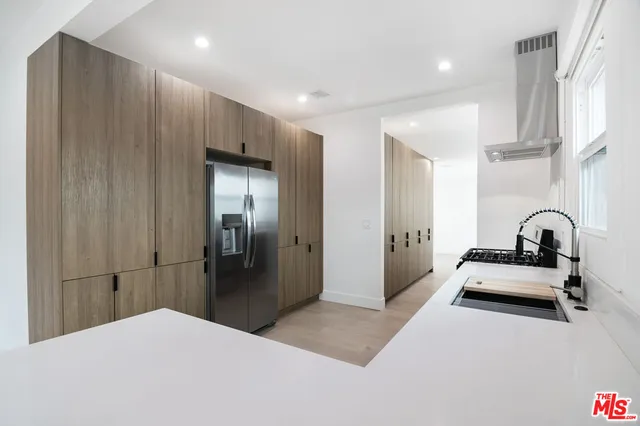 a kitchen with a refrigerator and a sink