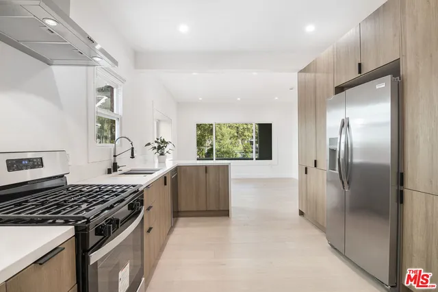 a kitchen with cabinets appliances and a sink