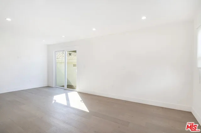 an empty room with windows and entrance