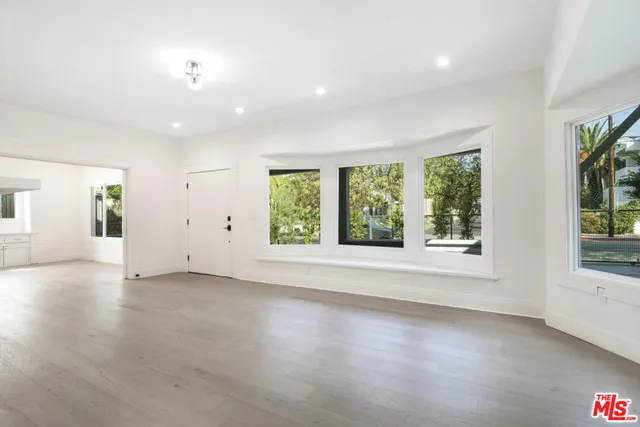 an empty room with windows and entrance